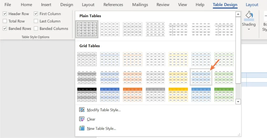 Screenshot of the 'Table Design' tab in a word processing program, showing various table style options under 'Plain Tables' and 'Grid Tables.' An orange arrow points to one grid table style. On the left, checkboxes for 'Header Row,' 'Total Row,' 'Banded Rows,' 'First Column,' 'Last Column,' and 'Banded Columns' are visible. Bottom options include modify, clear, and create new table style.