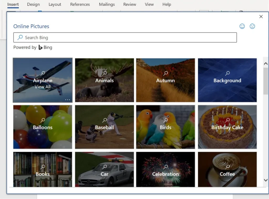 Screenshot of Microsoft Word's 'Online Pictures' search feature. A search bar labeled 'Search Bing' appears at the top, powered by Bing. Below it, twelve image categories are shown in a grid: Airplane, Animals, Autumn, Background, Balloons, Baseball, Birds, Birthday Cake, Books, Car, Celebration, and Coffee. Each category includes a thumbnail image and a magnifying glass icon for browsing more images.