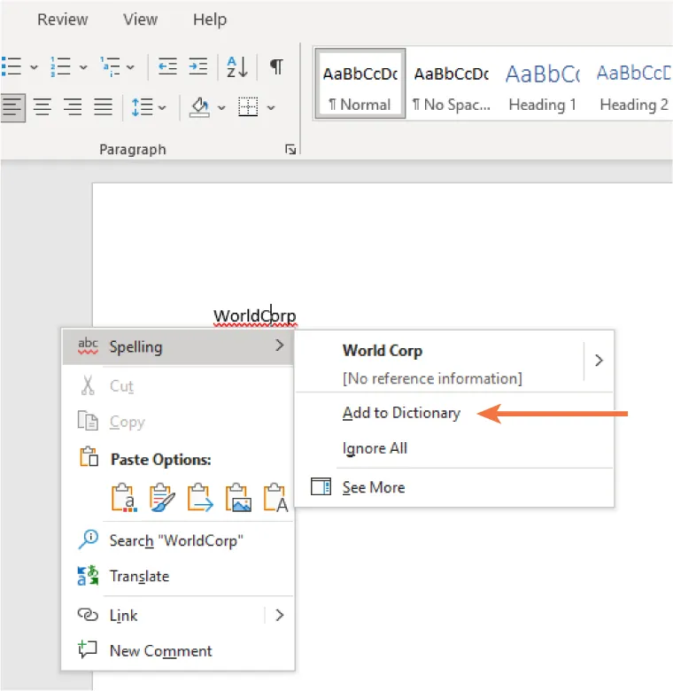 A screenshot of a Microsoft Word document showing the word "WorldCorp" underlined in red to indicate a spelling error. A right-click context menu is open with spelling suggestions and options including "Add to Dictionary," "Ignore All," and "See More." An orange arrow points to the "Add to Dictionary" option. The toolbar at the top displays formatting tools such as font styles and paragraph settings.