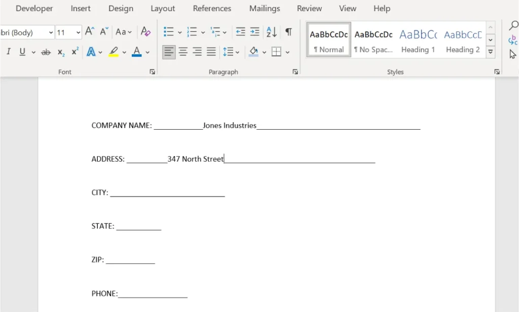 Screenshot of a Microsoft Word document template for entering company information. The template includes labeled fields for COMPANY NAME, ADDRESS, CITY, STATE, ZIP, and PHONE. "Jones Industries" is entered in the COMPANY NAME field, and "347 North Street" is entered in the ADDRESS field. The remaining fields are blank. The Word toolbar is visible at the top with formatting options.