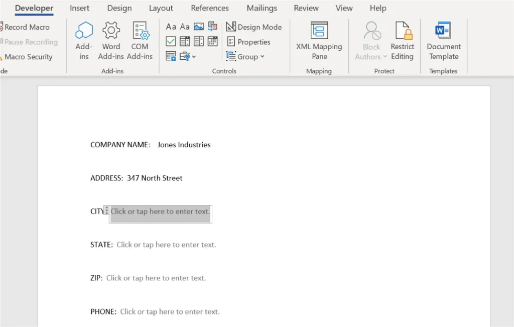 Screenshot of a Microsoft Word document in Developer mode. The document includes labeled fields for entering company information: COMPANY NAME is filled with "Jones Industries," ADDRESS with "347 North Street," while CITY, STATE, ZIP, and PHONE fields display placeholder text "Click or tap here to enter text." The Developer tab is active, showing toolbar options such as Record Macro, Add-ins, Design Mode, and XML Mapping Pane.