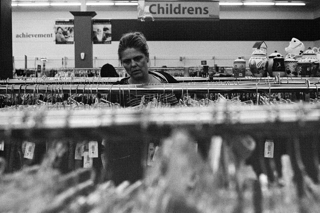 Photo of women going through clothing racks