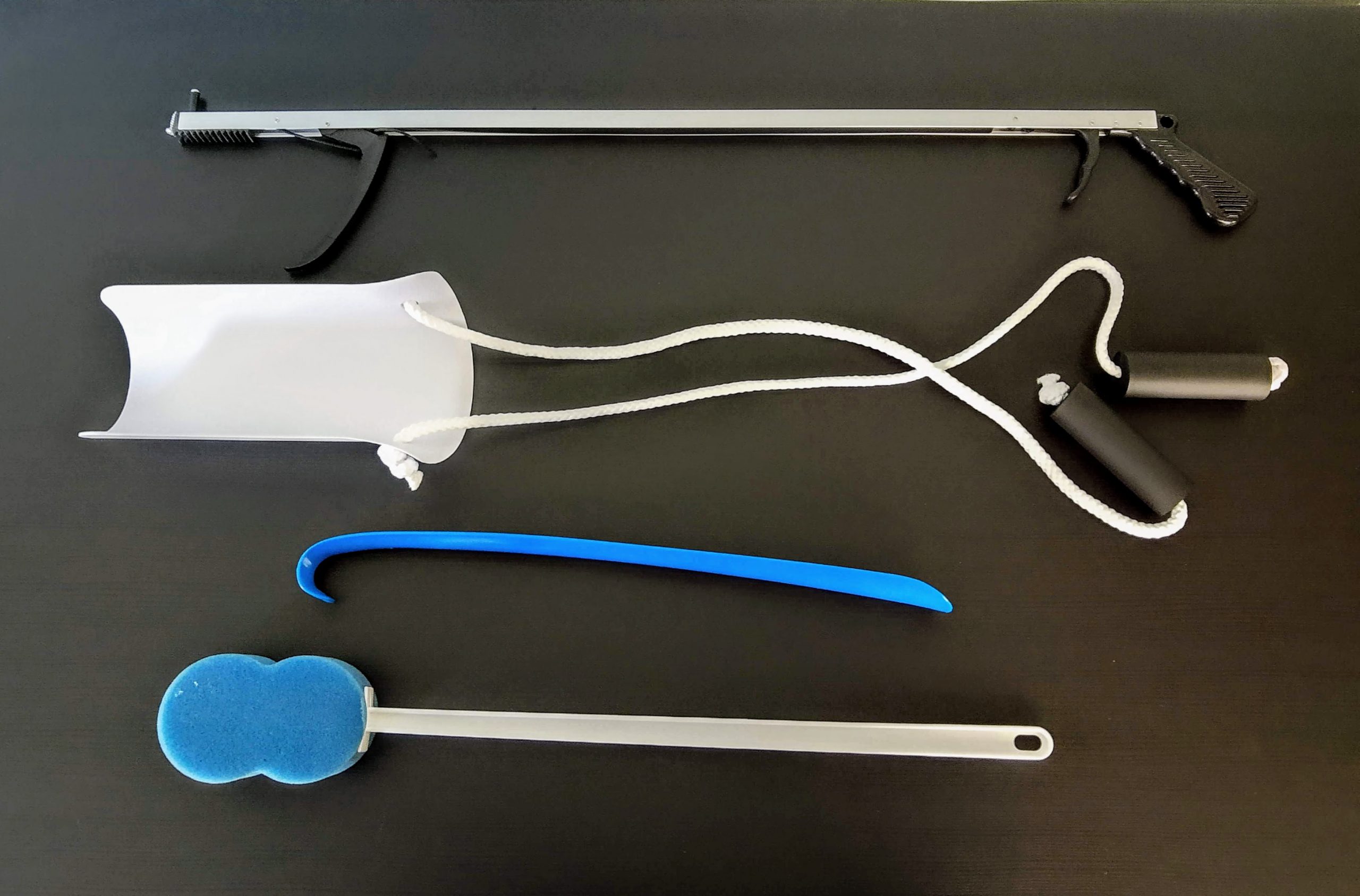 Photo showing Reacher, Sock Aid, Elongated Shoe Horn, and Elongated Bath Sponge