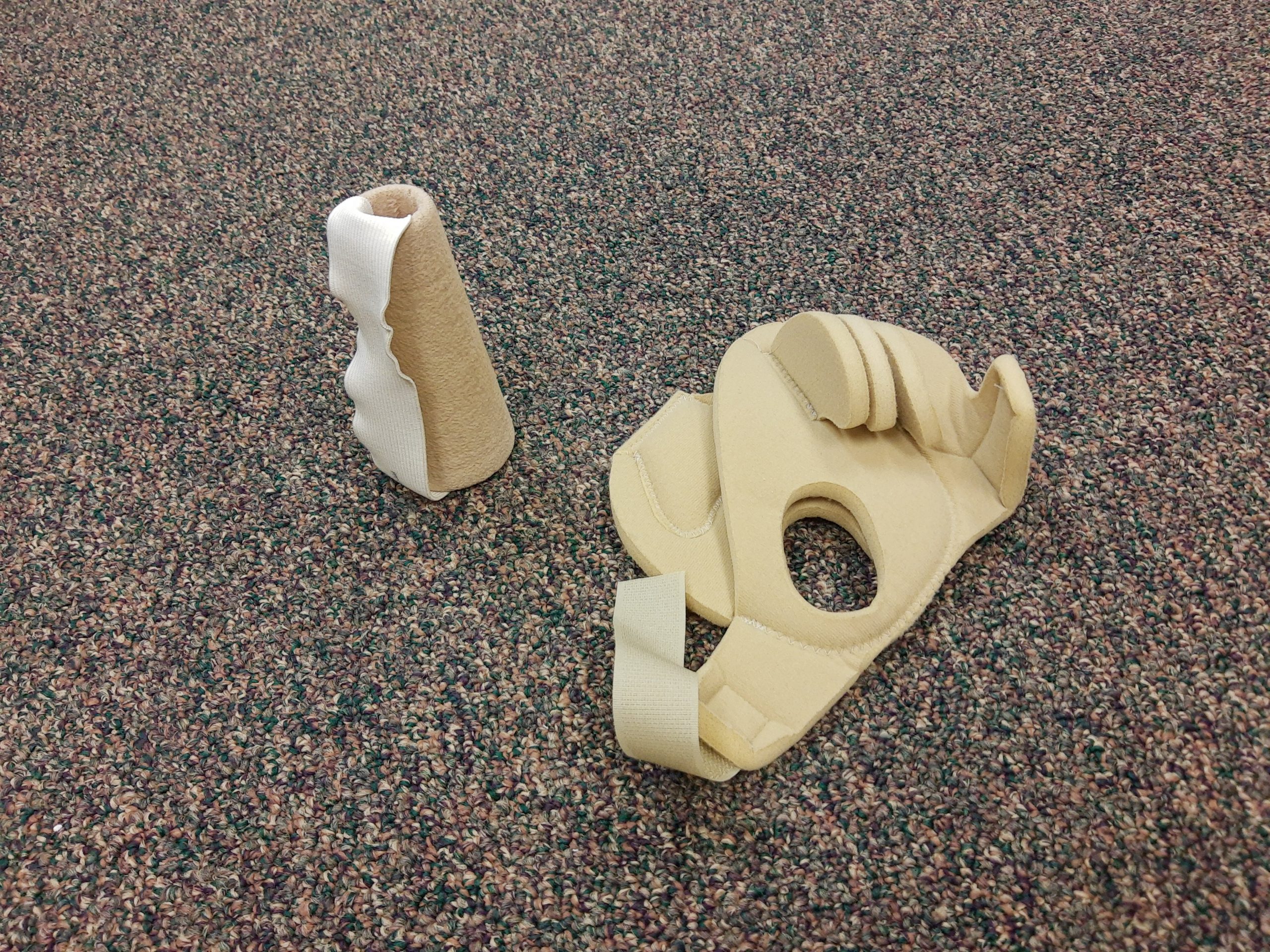 Photo showing Cone to Prevent Hand Contracture (left) and a Palm Protector (right)