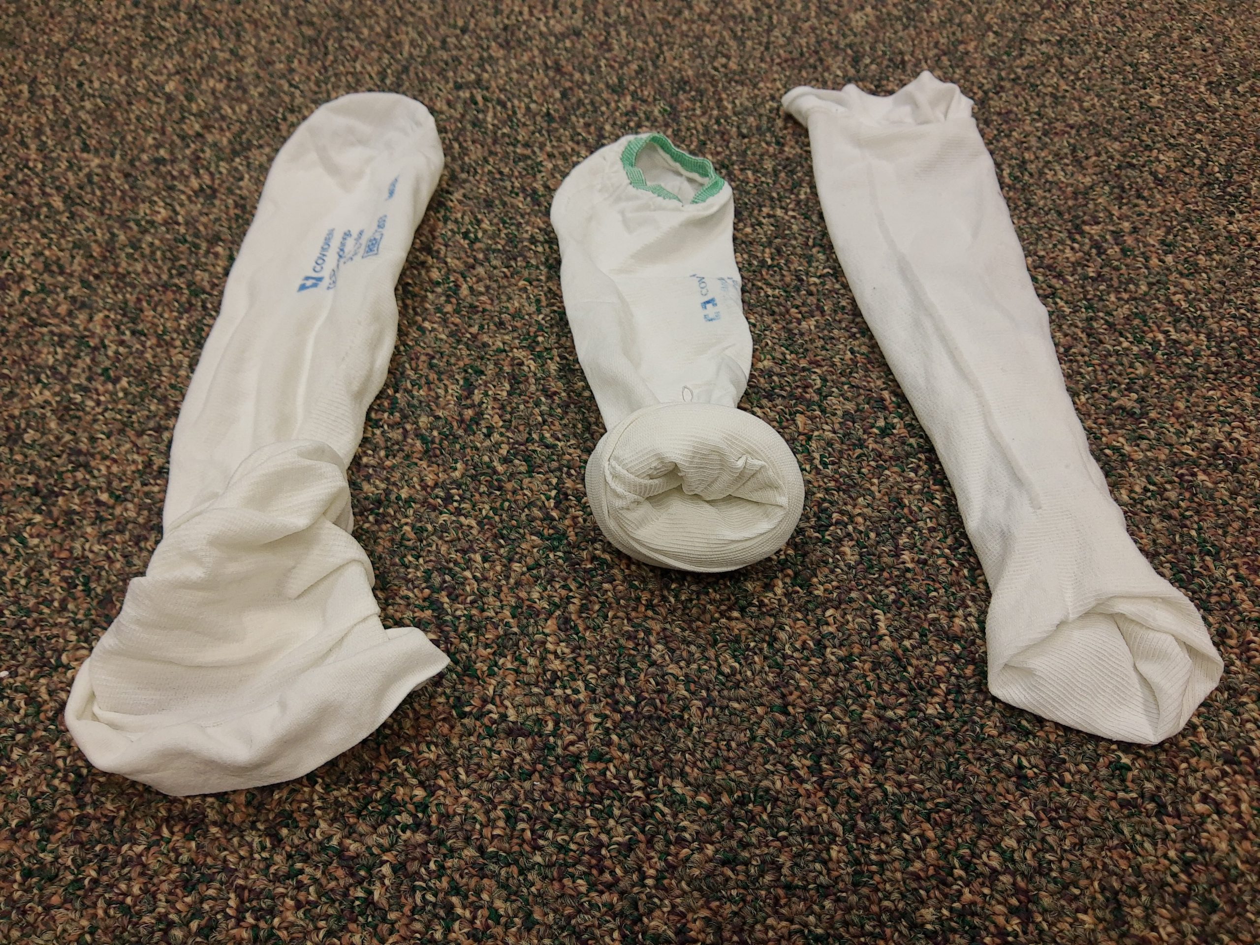 Photo showing TED Hose Gathered, Rolled, and Turned Inside Out to Place on Client’s Heel