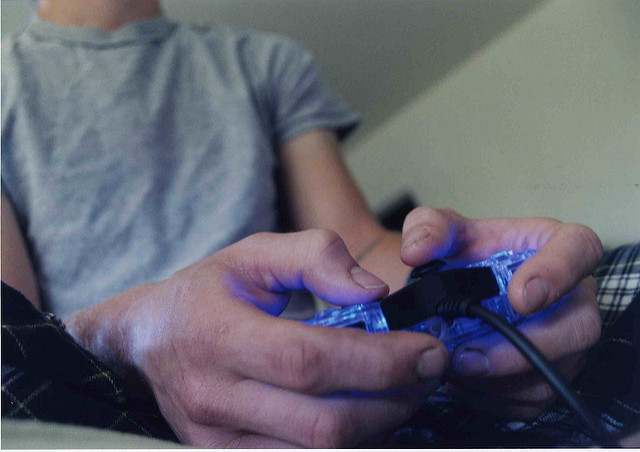 Close up of a person with a video game controller.