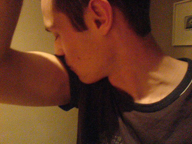 Close up of a person "kissing" their elbow.