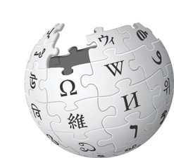 "An incomplete globe composed of puzzle pieces, each featuring characters from different writing systems, representing the Wikipedia logo."