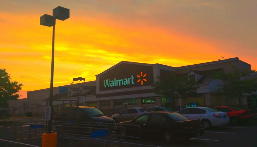 Photo of a Walmart store with the sun setting in the background.