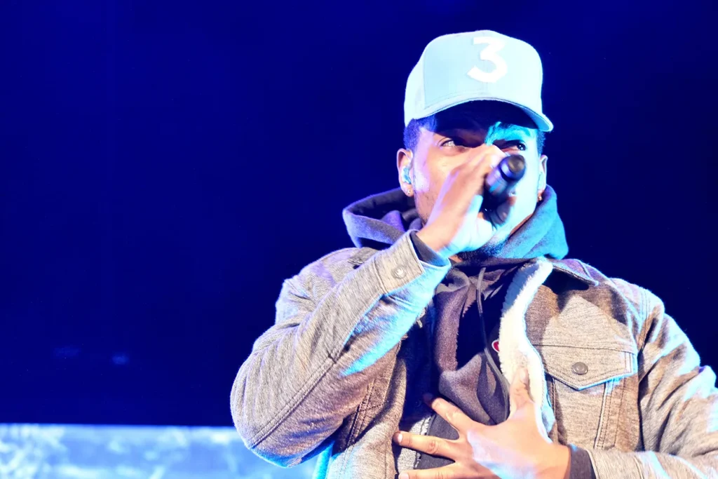 Photo of Chance the Rapper holding a microphone. 