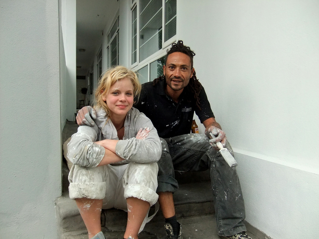Photo of a man and women sitting next to each other on a step. 